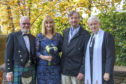 Newlyweds Kate and Paul Wright (centre) with church beadle Ian Lowden and Reverend Marjory MacLean.