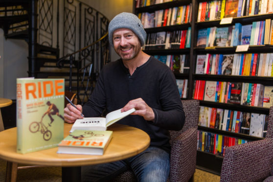 John Buultjens signing copies of his book Ride at Waterstones.