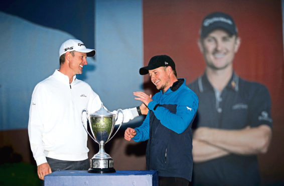Justin Rose presents the trophy to Eddie Pepperell after winning during day four of the British Masters at Walton Heath Golf Club, Surrey. PRESS ASSOCIATION Photo. Picture date: Sunday October 14, 2018. See PA story GOLF Masters. Photo credit should read: Steven Paston/PA Wire. RESTRICTIONS: Editorial use only, No commercial use without prior permission.