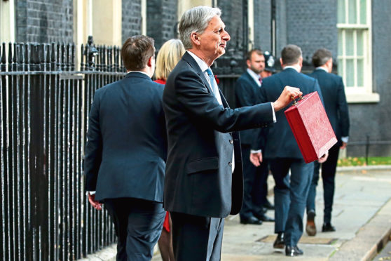 Chancellor of the Exchequer, Philip Hammond, presents the red Budget Box as he departs 11 Downing Street to deliver his 2018 budget announcement to Parliament.
