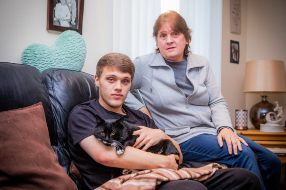 Curtis the cat with his owners Charlie and Christine.