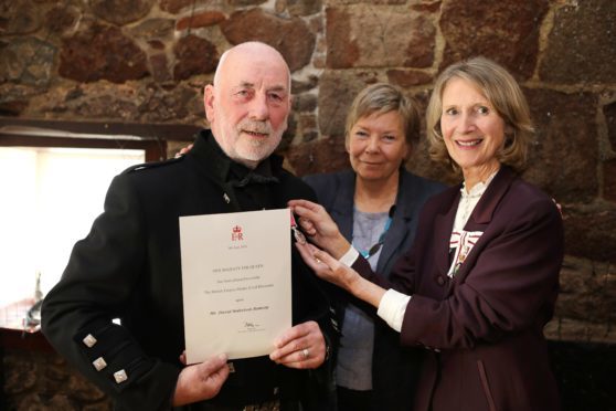 Dave Ramsay, with wife Dorothy, receives his BEM from the Lord Lieutenant of Aberdeenshire Carol Kinghorn.