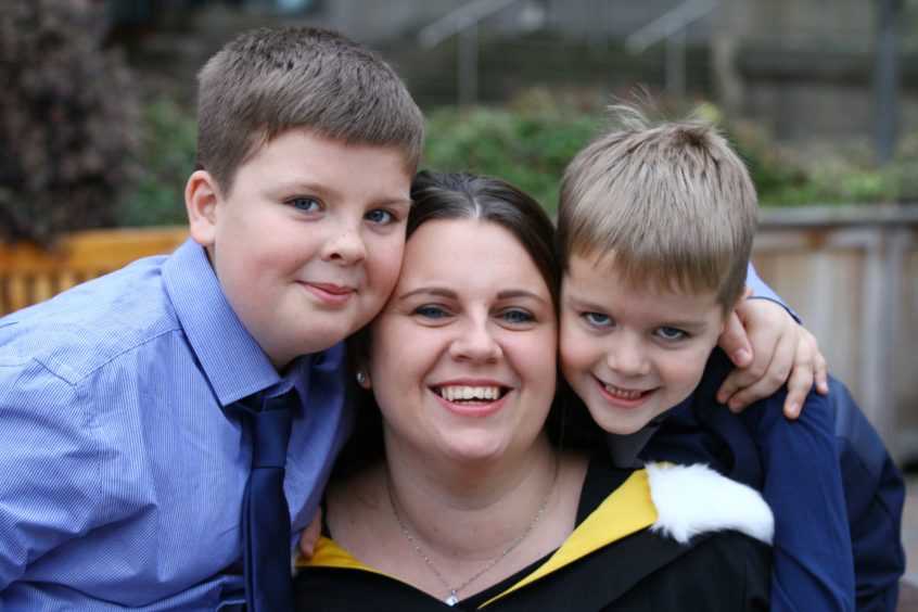 Nikki Campbell from Fife celebrates her degree in nursing with her sons Max (6) and Noah (9).