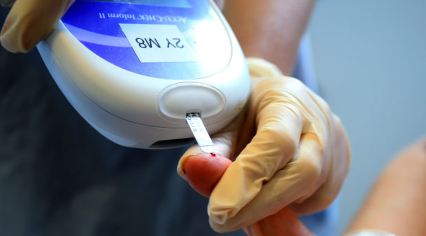 A nurse giving a patient a diabetes test. (library photo)