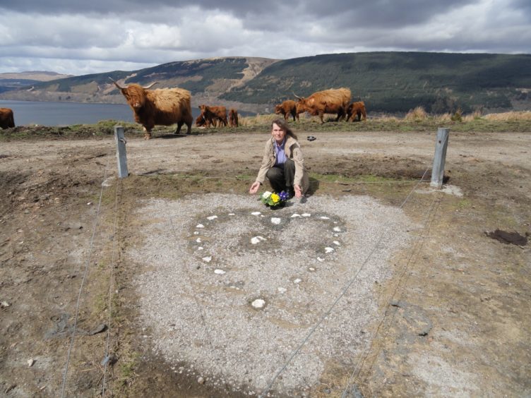 Jess Smith kneeling next to the Tinkers' Heart.