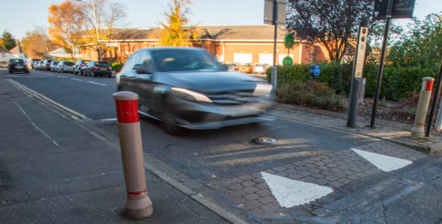 The bollard has been disabled and now allows traffic from both directions.