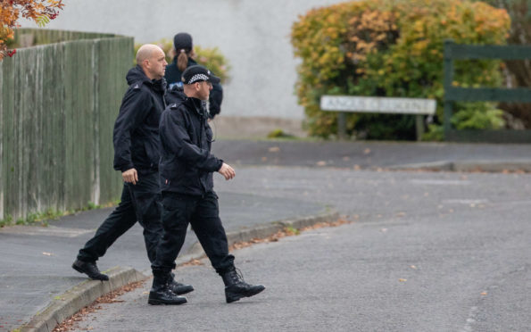 Police go door-to-door in Highland Road, Crieff, near where Martyn Cruickshank was last seen.