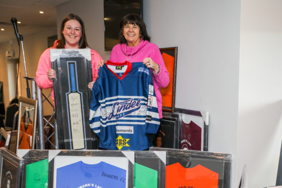 Clare Jamieson from Alzheimer Scotland and Amanda Kopel with some of the shirts sold at auction.
