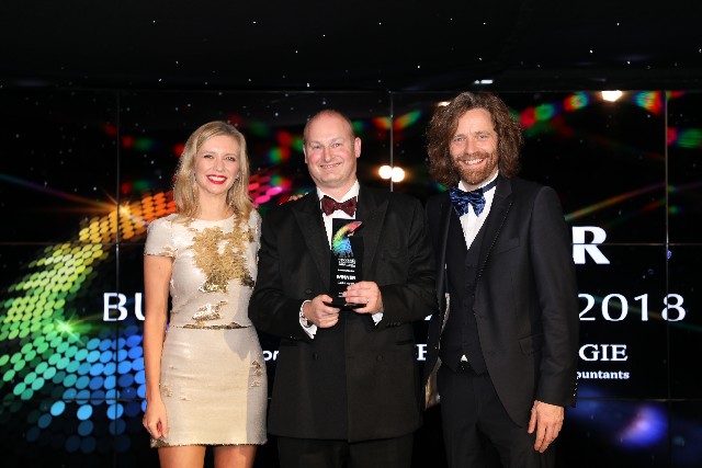 Castle Water chief executive John Reynolds accepts the Business of the Year prize presented by Rachel Riley and David Smith of Henderson Loggie.