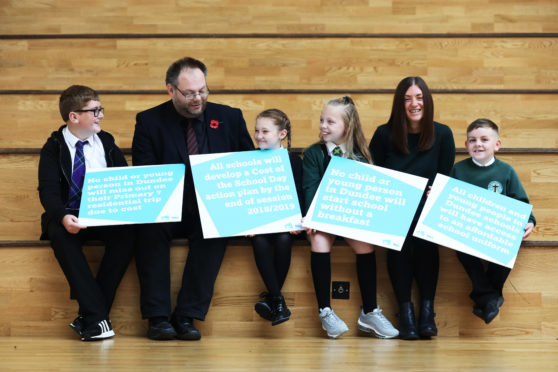 Councillor Stewart Hunter and Child Poverty Action Group Scotland project co-ordinator Susan Epsworth with pupils from Longhaugh and St Francis primary schools.