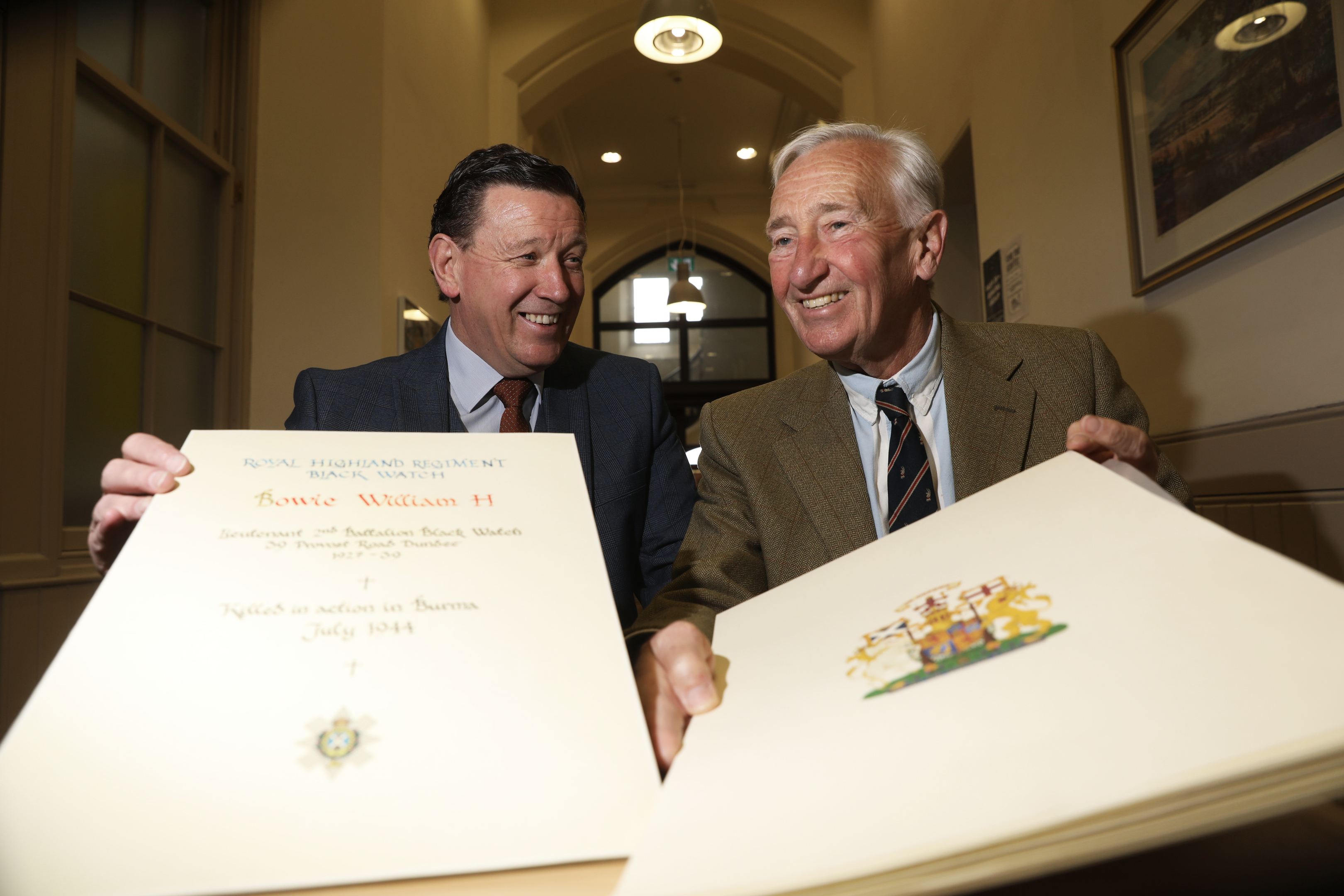 Morgan Academy chemistry teacher Mike Mulholland and Stuart Allan, Former Chairman of the Morgan Academy Former Pupils' Association with pages from the book