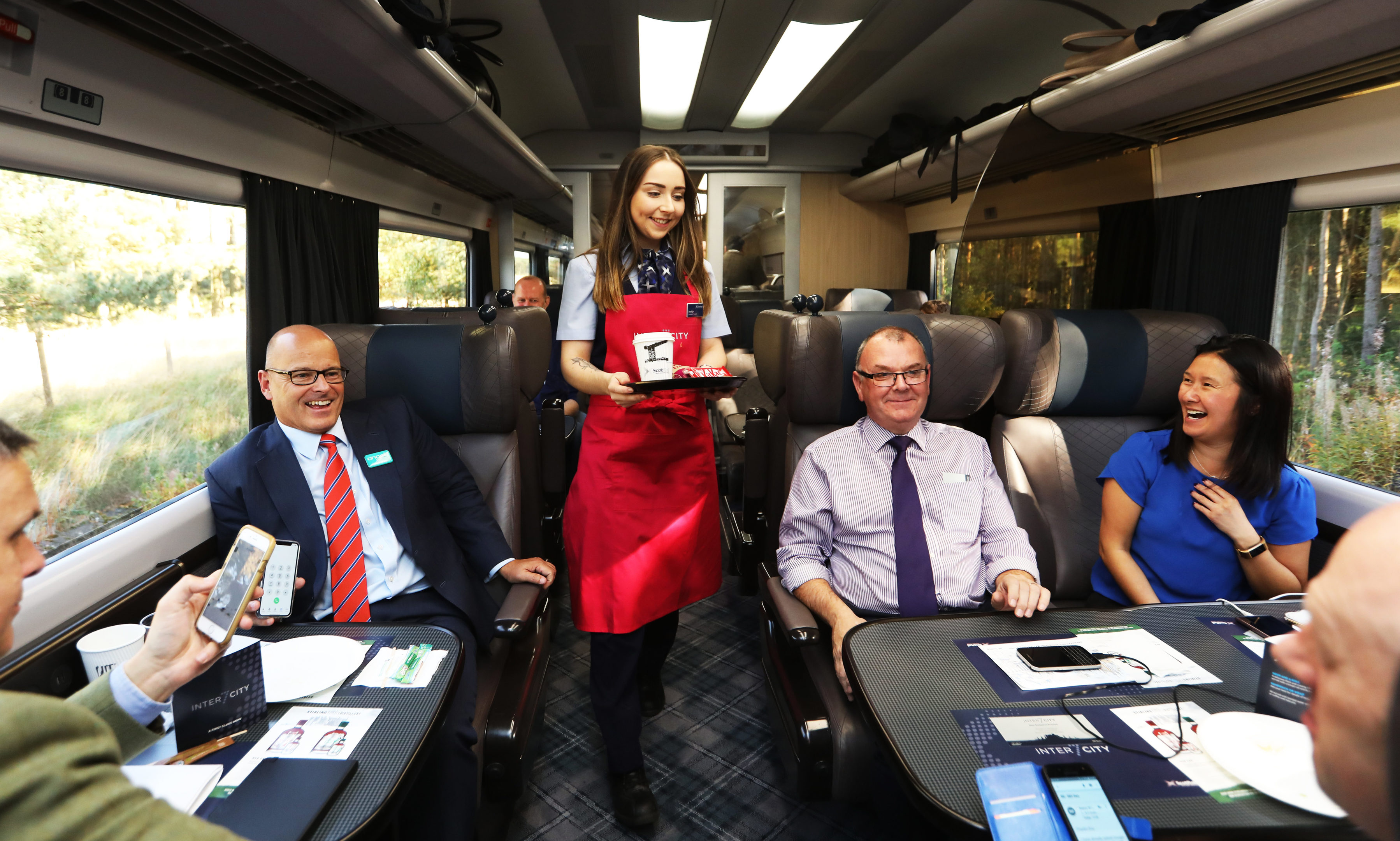 Brooklyn Kerr, a ScotRail hospitality assistant, supplying drinks to the first class cabin.