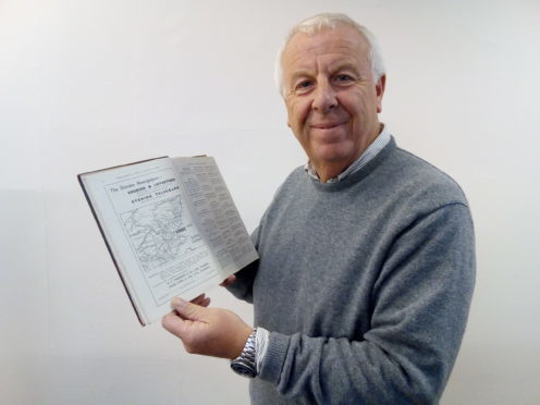 Rotarian Clive Murray with the Dundee of Commerce 1936 centenary souvenir book.