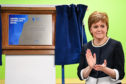 Nicola Sturgeon unveils a plaque marking the official opening of the new trauma centre at Ninewells Hospital.