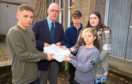 John Swinney receives a petition from pupils Sol Archibald, Duncan Fairlie Tori Rennie and Ben Gilyeat.