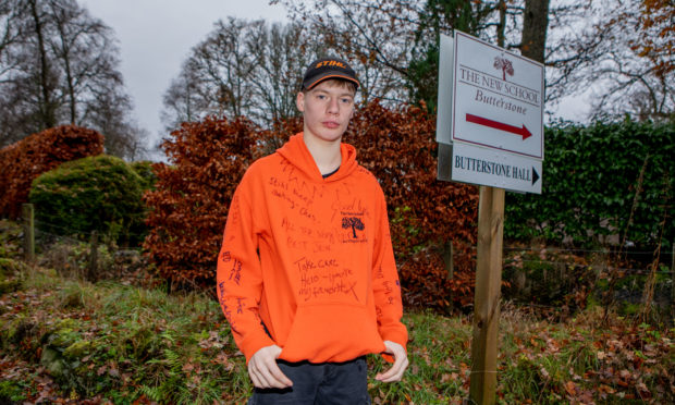 Former Butterstone pupil Duncan Fairlie, aged 16, pupil, with his school top signed by classmates.