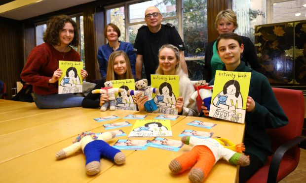 Illustration students Cara Rooney, Lauren Swan, Detta Carfrae and Adina Ziebart with, standing, lecturer Natalie Russell, PC Andrew Kerr and Jane Pengelly of Children 1st.