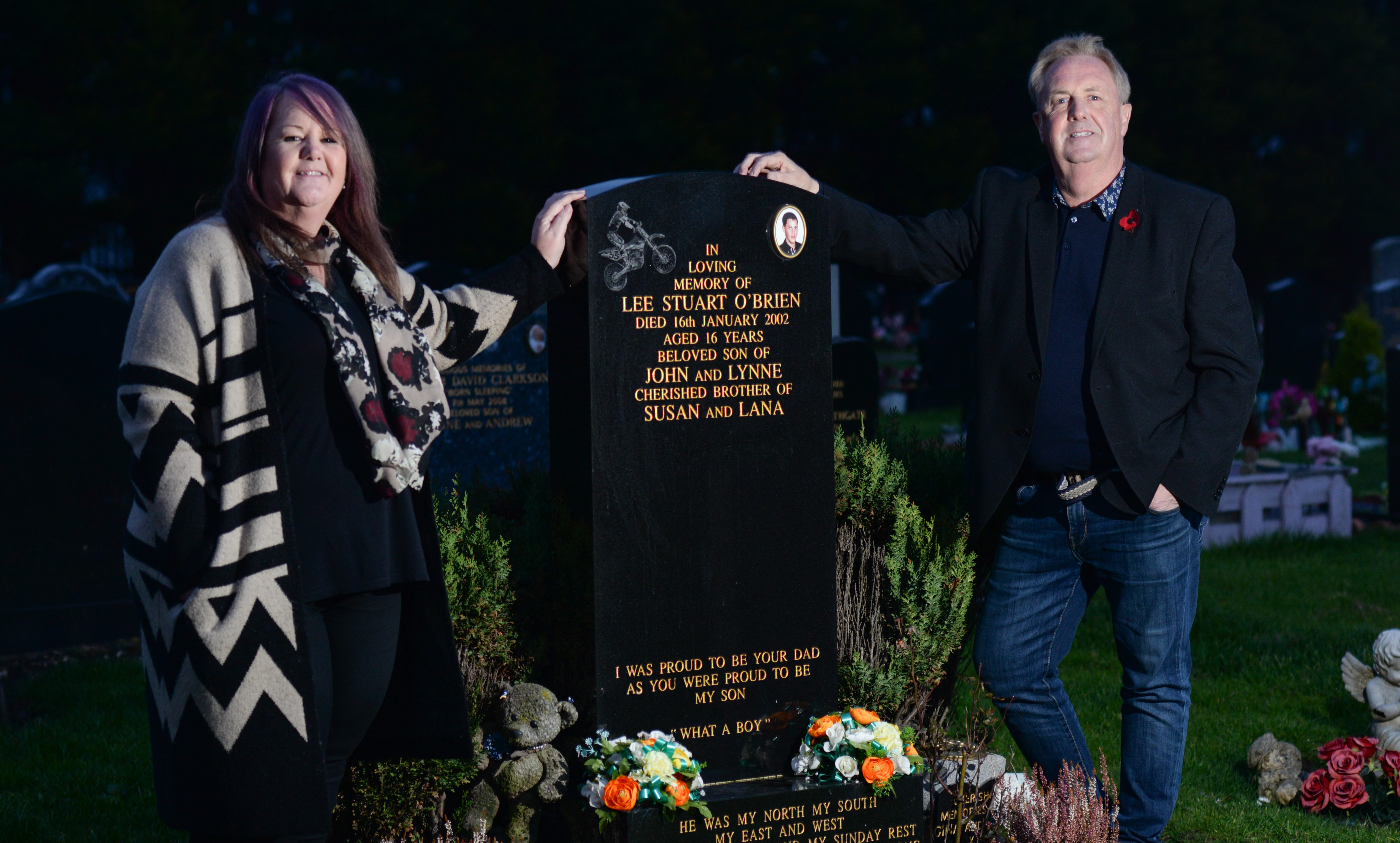 Councillor John O'Brien and his sister Katy Ovenstone beside John's son's grave.