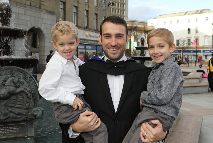 Christopher Nixon celebrates his post grad in further education with his sons Sebastion (3) & Ellis (6).
