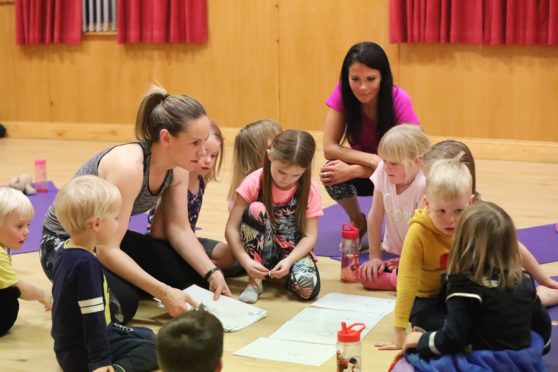Gayle joins in a children's yoga class run by Linda Mackie ikn Wellbank Village Hall in Angus.