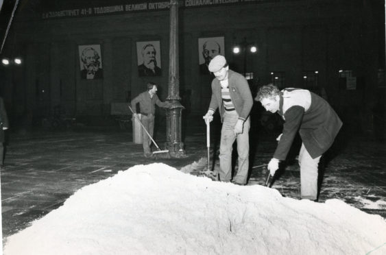 Work going on as snow is brought to the City Square in 1983.