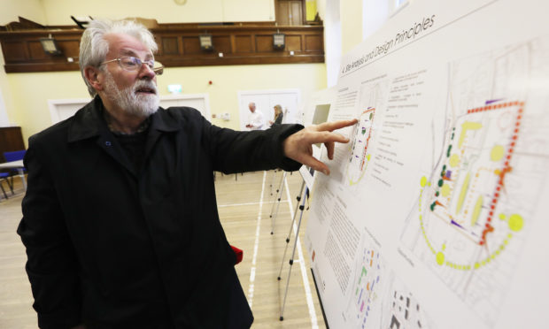 The Courier, CR0004829, News, Paul Reoch story, A public event is taking place at Kinnoull Parish Church, Perth, to show the designs for a housing development to be built on land formerly occupied by Hillside Hospital. 
Picture shows; Local resident Michael Glen inspecting the plans. Thursday 22nd November, 2018. Mhairi Edwards/DCT Media