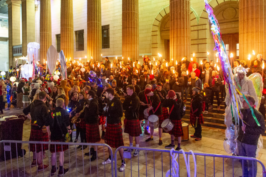 The torch-lit procession arrives and lines up on the Caird Hall steps.