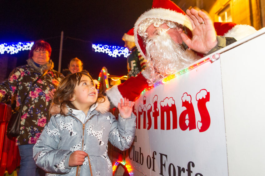 A youngster meets Santa at a past Forfar Christmas lights event. 