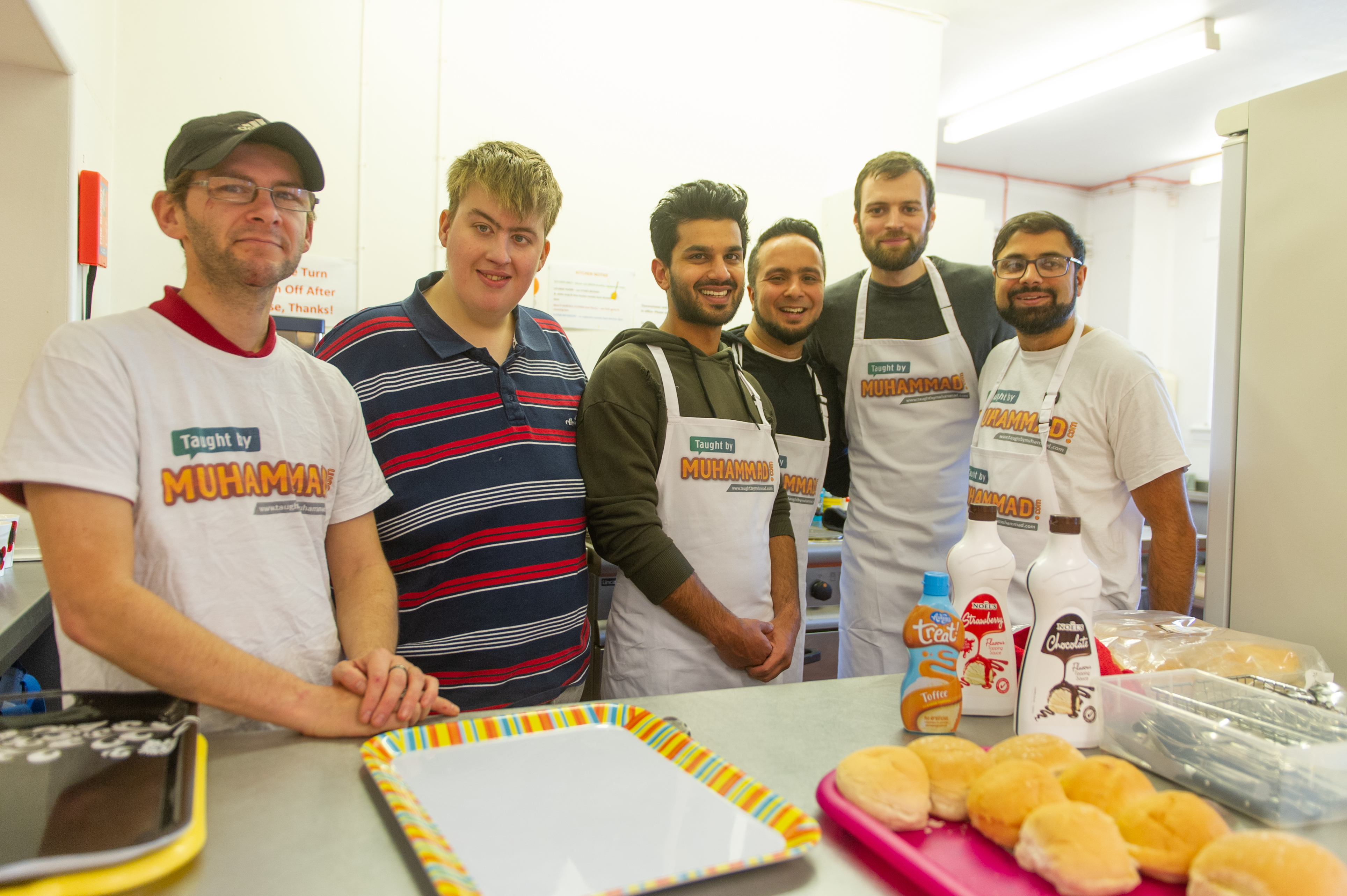 The Taught by Muhammed Kirkton support cafe in action - l to r - volunteers - Kevin Marnie and Stevie Lee, with volunteers and project managers within the organisation - Umer Farooq, Faisal Hussein, Isa Mallick and Rizwan Rafik.