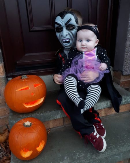 Kaiden, 4, and Keira, 5 months, preparing to spook their neighbours.