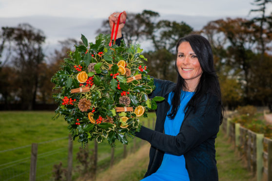 Gayle shows off the stunning festive wreath she made at Balgove Larder.