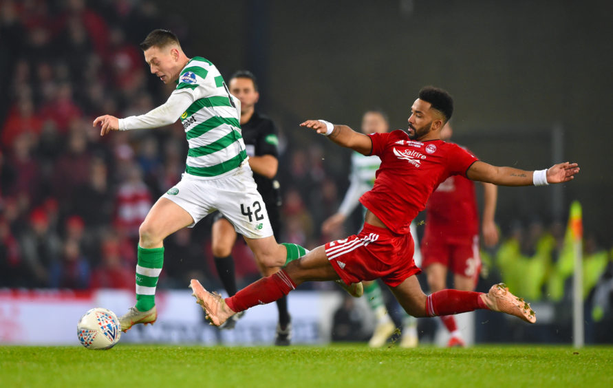 Celtic's Callum McGregor is challenged by Aberdeen's Shay Logan