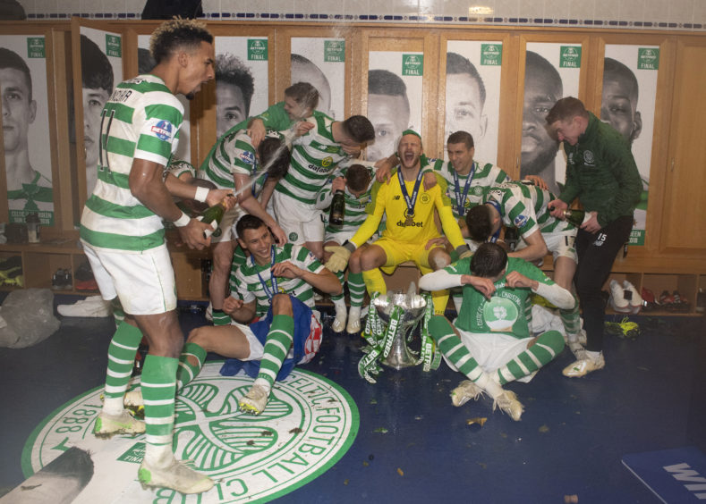 Celtic's players celebrate in the dressing room after winning the Betfred Cup