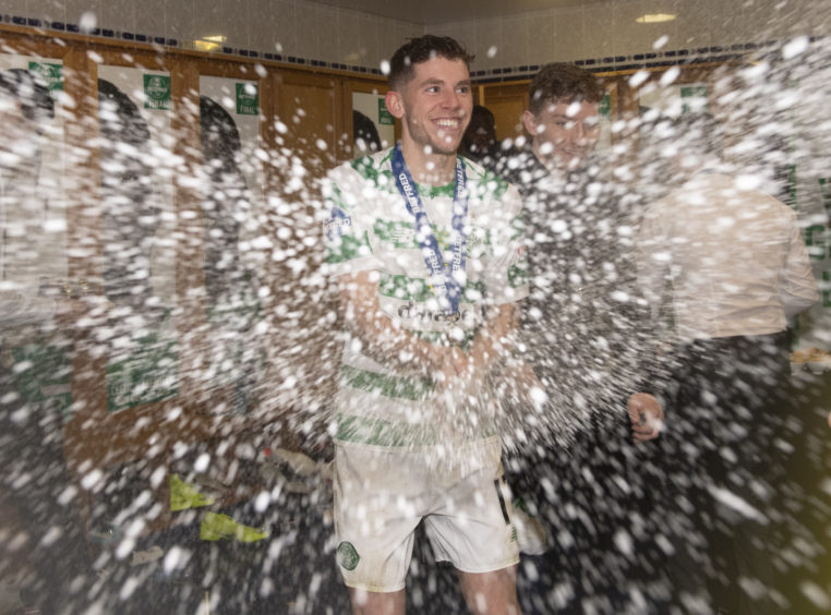 Celtic's Ryan Christie celebrates in the dressing room after winning the Betfred Cup