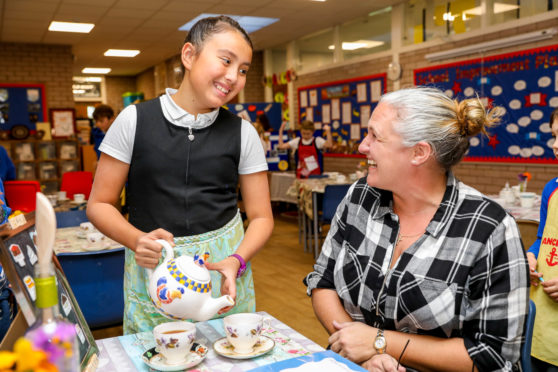 Natalie Fraser serves a cup of tea to local resident Meg MacKinnon.