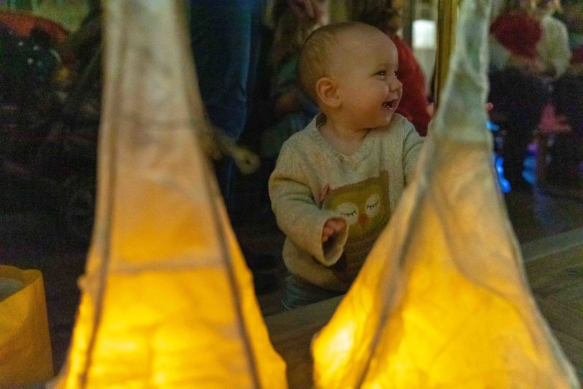 Baby Harriet Bowyer (11mth) is excited with the lanterns.