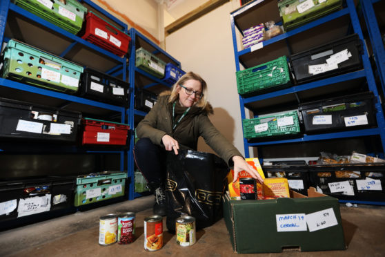 Perth and Kinross food bank coordinator Eleanor Kelleher preparing a parcel.