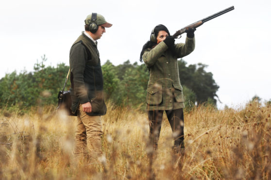 Gayle enjoys a clay target shooting lesson with David Harris at Gleneagles Shooting School.