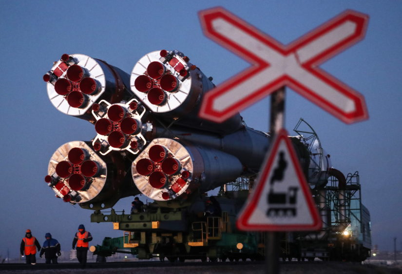 A Soyuz-FG rocket booster carrying the Soyuz MS-11 spacecraft being transported from an assembling facility to a launch pad at the Baikonur Cosmodrome.