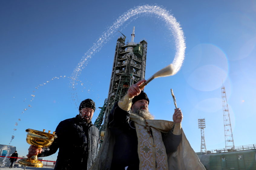 A Russian Orthodox priest during the blessing of a Soyuz-FG rocket booster carrying the Soyuz MS-11 spacecraft at Baikonur Cosmodrome.