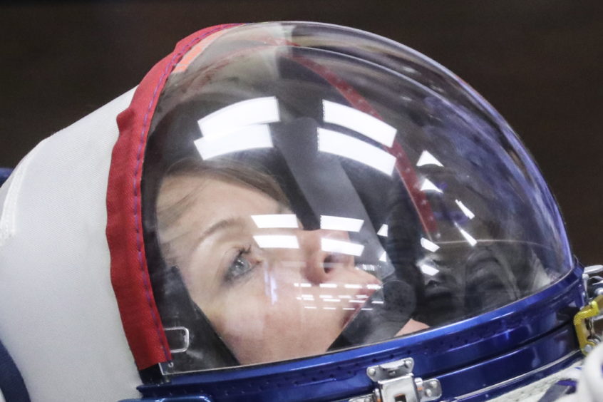 Astronaut Anne McClain during a spacesuit check before a launch of the ISS Expedition 58/59 crew to the International Space Station.