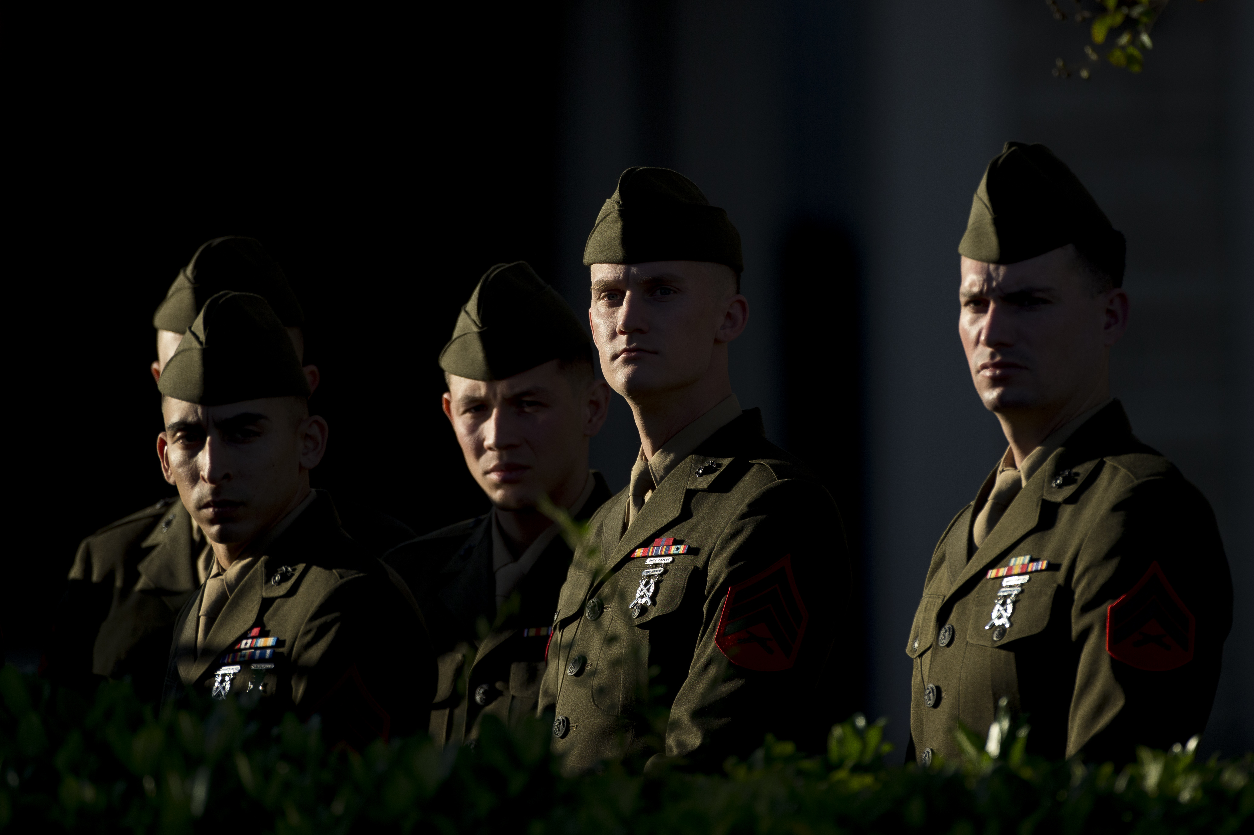 Members of the U.S. Marine Corps in their dress greens stand outside where the remains of President George H.W. Bush are kept before the first departure ceremony.