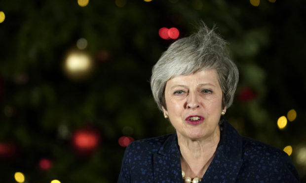 British Prime Minister Theresa May gives a speech after winning the confidence vote on December 12, 2018 in London, England.