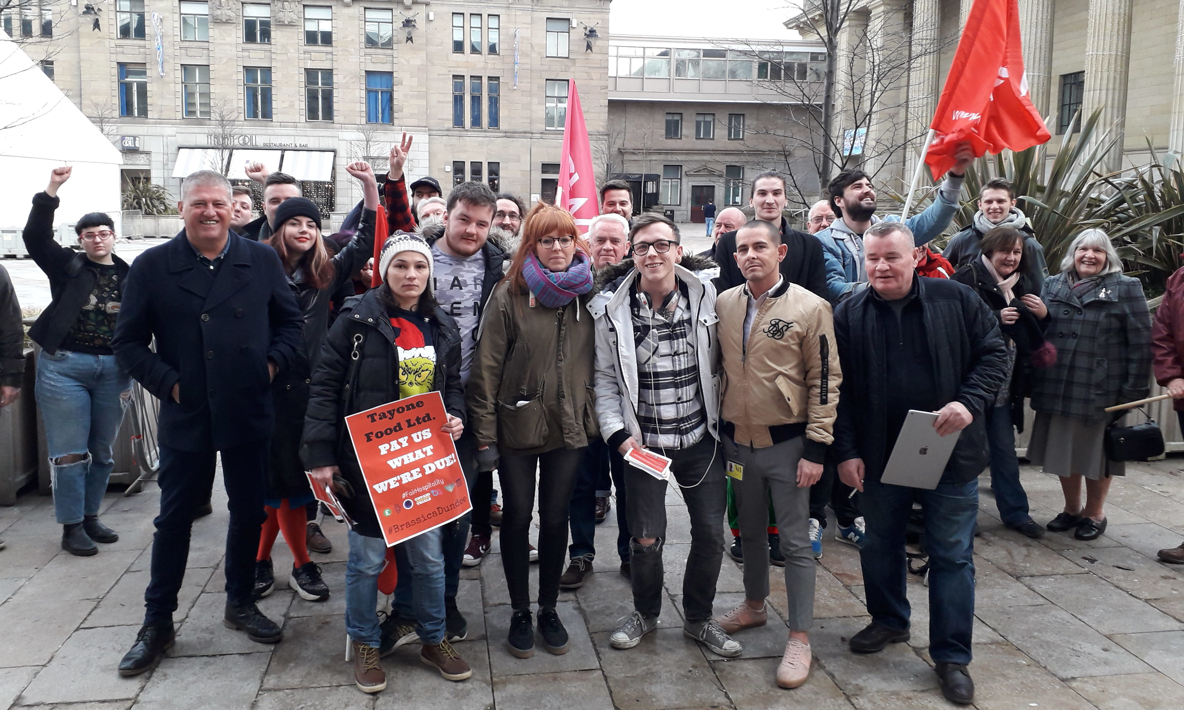 Union members and former Brassica employees celebrate their "small victory" outside the City Chambers on Thursday.