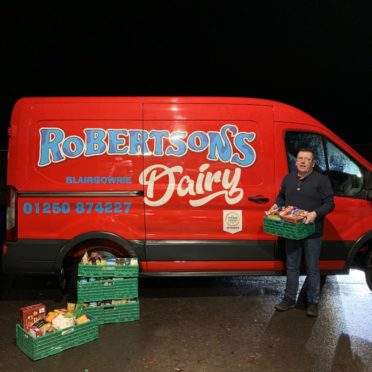 Gavin Robertson, owner of Robertson's Dairy, with some of the food bank donations.