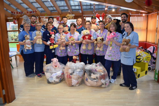 Stars players at Ninewells hospital last year donating bears which were thrown on to the ice.