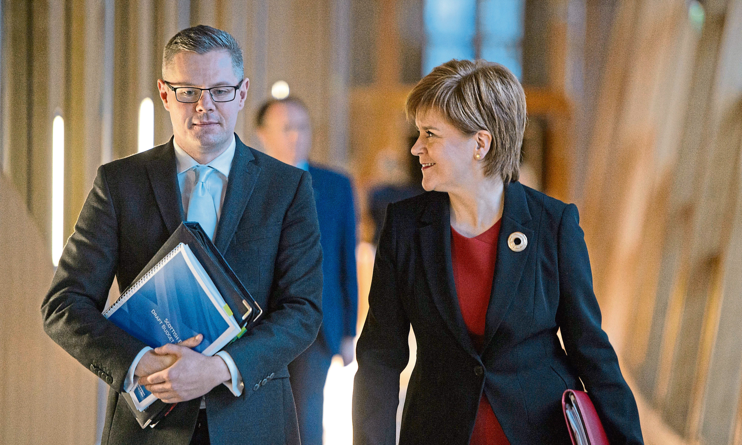 First Minister Nicola Sturgeon and Finance Secretary Derek Mackay arrive to delivering his draft Budget for 2018-19 at the Scottish Parliament in Edinburgh.
