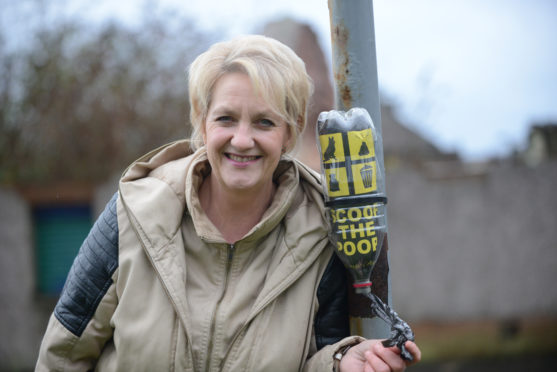 Dog owner and community council member Shona Lumsden with one of the bottle dispensers