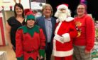 Debbie Maxwell, left, and Linzie Kerr, right, with Aidan Anderson, David Torrance MSP and Heather Bonner as Santa at Saturdays fundraising fair
