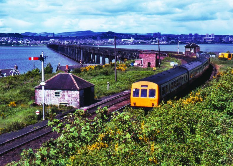 A train formed of two Class 101 units comes off the Tay Bridge at Wormit in 1981